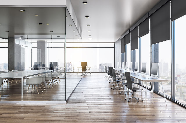 Bright commercial office with clean floors, glass partitions, and windows